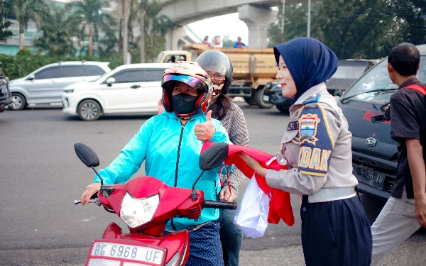 Foto Pembagian bendera merah putih gratis dilakukan oleh Pemerintah Kota Palembang di Simpang Lima DPRD Kota Palembang, Kamis (15/8/24). Foto: Wisnu Akbar Prabowo