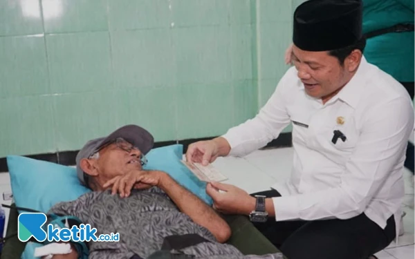 Foto Calon Bupati Sidoarjo Subandi saat menjabat Plt Bupati Sidoarjo berbincang dengan seorang lansia yang mendapatkan jaminan kesehatan. (Foto: Dinas Kominfo)