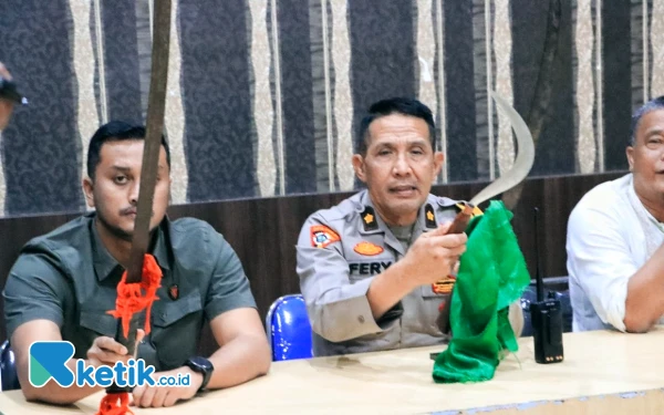 Foto Kabag Ops Polres Labuhanbatu (kanan) didampingi Kasat Reskrim memperlihatkan senjata tajam yang disita dari anak remaja tergabung di geng motor. (Foto : Satreskrim Polres Labuhanbatu for Ketik.co.id)