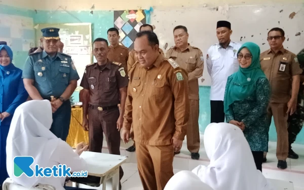 Foto Pj Bupati Simeulue, Reza Fahlevi, berinteraksi dengan siswa penerima manfaat MBG (Helman/Ketik.co.id)