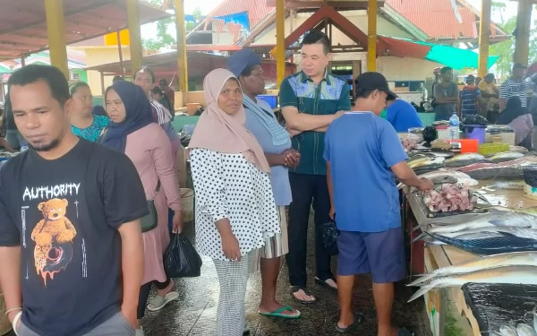 Foto Bupati Freddy Thie saat interaksi dengan para pembeli ikan di pasar ikan (dok.humas pemda)