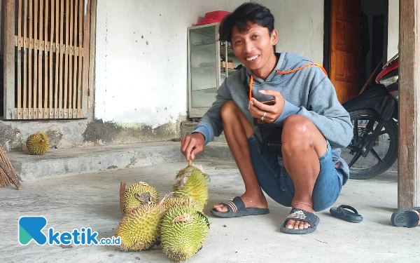 Foto Pembeli Feri sumringah saat mendapatkan buah durian incaranya. (Foto: Al Ahmadi/Ketik.co.id)