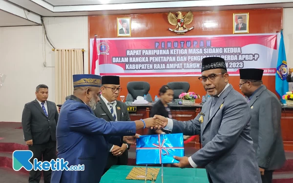 Foto Bupati Raja Ampat, Abdul Faris Umlati (kanan) dan Ketua DPRK Raja Ampat, Abdul Wahab Warwei (kiri) berjabat tangan sebelum penandatanganan berita acara sidang paripurna penetapan dan pengesahan Perda APBD-P Tahun 2023. (Foto: Abhie/ketik.co.id)