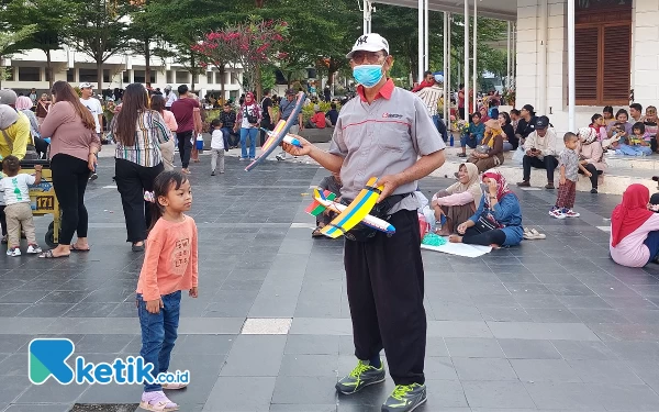 Foto Gatot saat menjajakan dagangannya kepada warga di Balai Pemuda. (Foto: Husni Habib/Ketik.co.id)