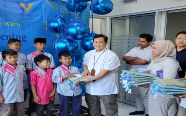 Foto Perwakilan WOM Finance memberikan bingkisan ke anak-anak panti asuhan. (Foto: WOM Finance)